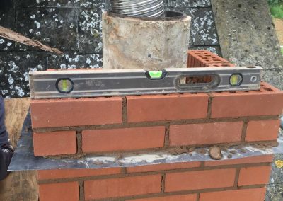 Bringing up the flue liners with the new chimney