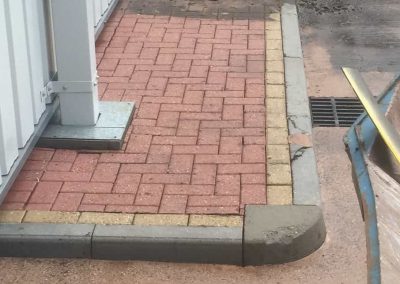 Cleaning down the pavement after the roof.