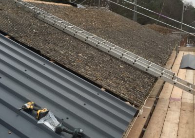 Removing profile 13 roofing sheets and replacing with box profile point 7 plastiso coated tin with anti-condensation drip membrane on the reverse side